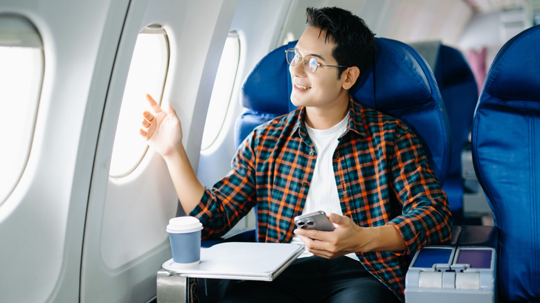 Person on a plane, looking out the window