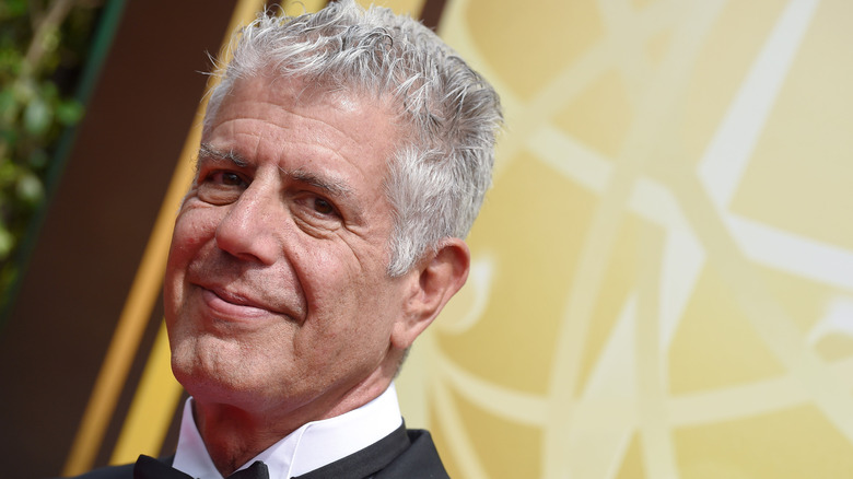 Medium-close shot of Anthony Bourdain wearing a tuxedo at an awards ceremony