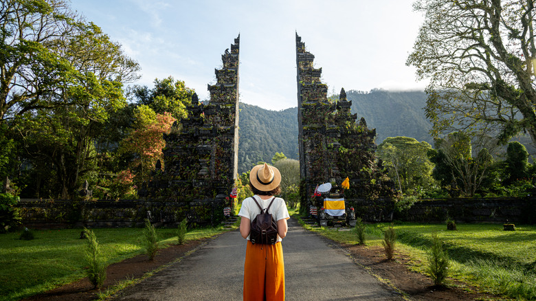 Tourist standing in front of a Balinese temple