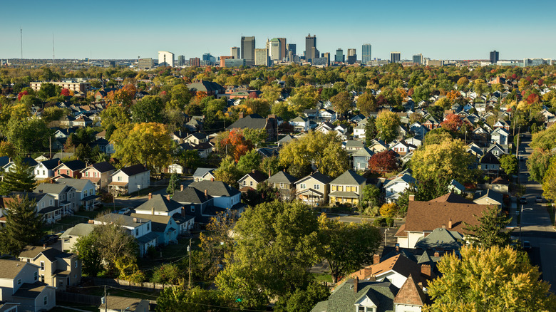 The Columbus, Ohio, skyline, with suburban homes and trees in the foreground