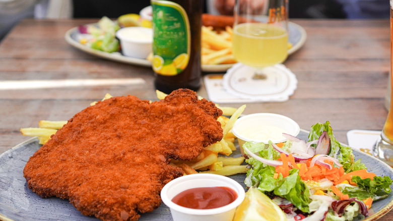 A close up of schnitzel and beer