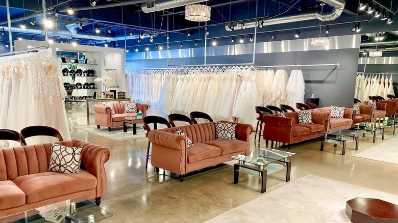 Inside of Luv Bridal with couches and dresses