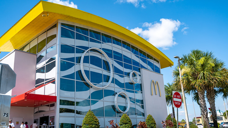 Exterior of McDonald's building with palm tree beside it