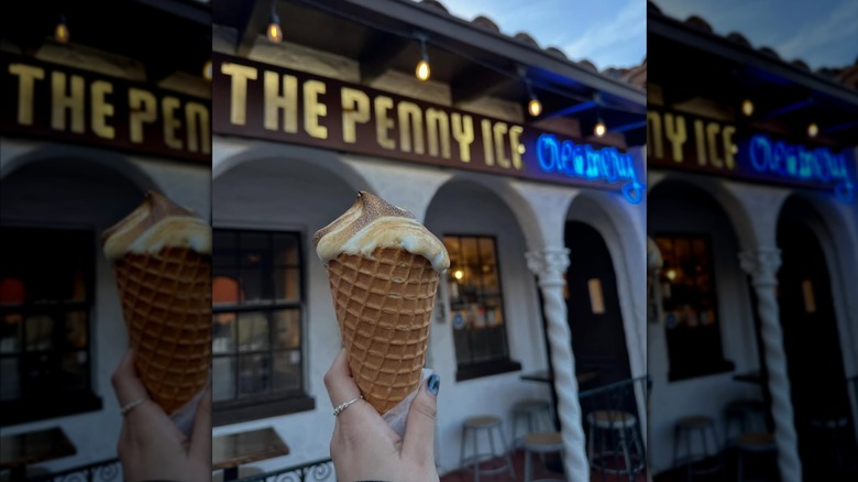Holding an ice cream cone in front of The Penny Ice Creamery in Santa Cruz