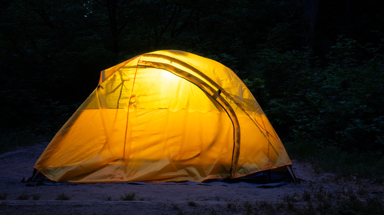 Camping tent at night with a light inside
