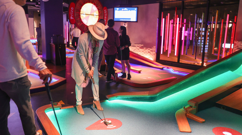 People playing mini golf at Puttshack in downtown Atlanta
