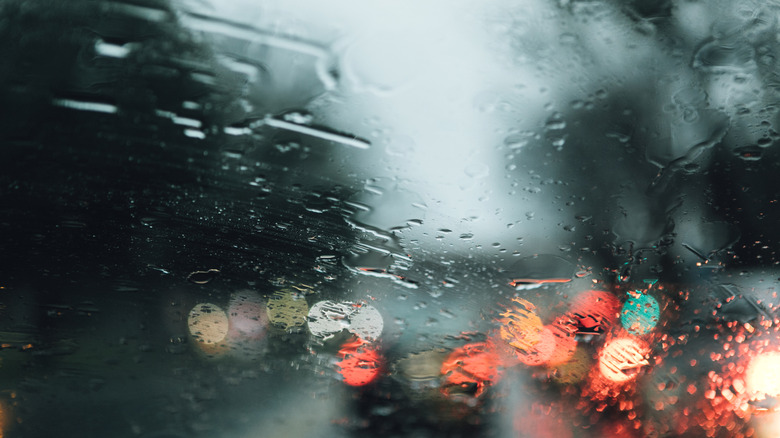 A rainy windshield in traffic