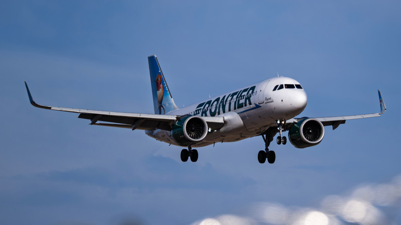 A Frontier airline plane in the air