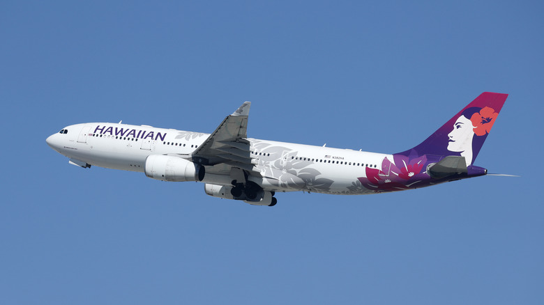 A Hawaiian Airlines passenger plane flying in the sky