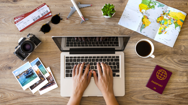 Woman using laptop making travel reservations