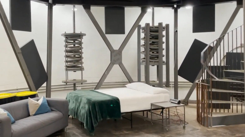 Titan Ranch room with bed, sofa, and stairs visible.