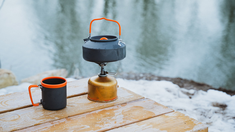 A tea kettle resting on a camping stove