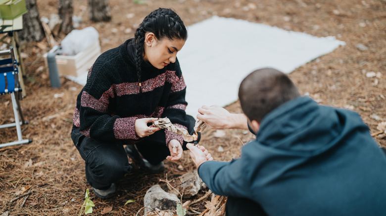 Two campers starting a fire