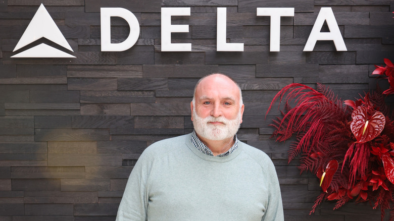 Chef José Andrés, who created Spanish-inspired meals for Delta One and Delta First cabins, standing under letters spelling "DELTA"