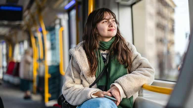 A woman looking out the window on a tram