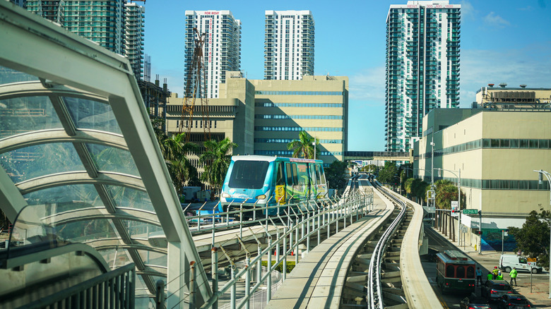 The Metromover in Miami with tall buildings behind it