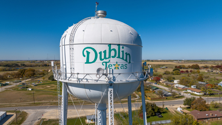 The Dublin, Texas, water tower with homes and farmland in the background