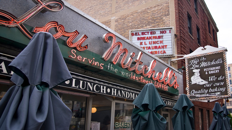 An outside view of retro neon sign at Lou Mitchell's diner