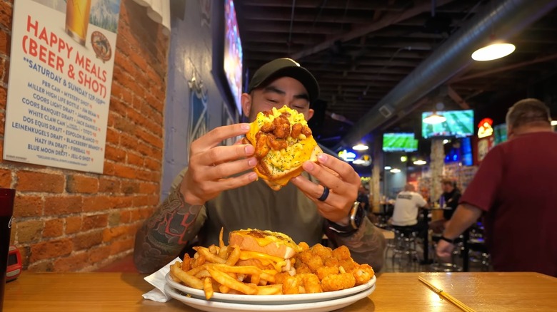 Nathan Figueroa holding a grilled cheese sandwich at Swanky's in Denver