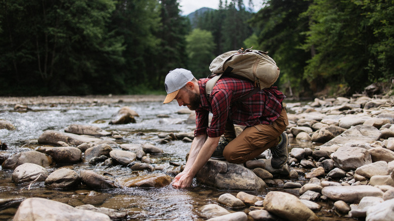 A man collecting water on the trail