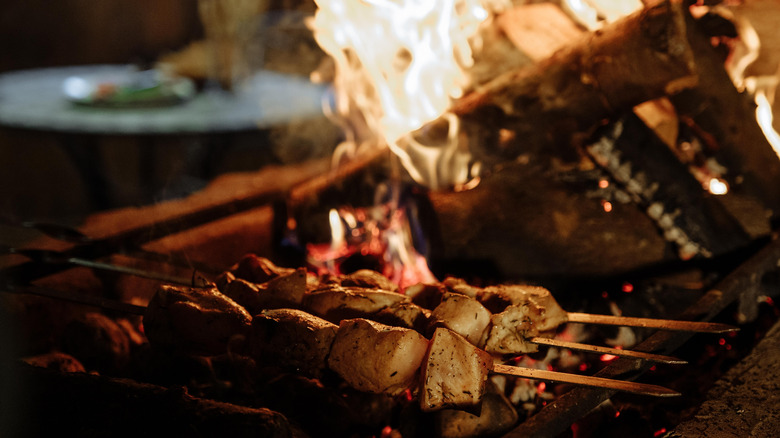 Chicken grilling over a fire