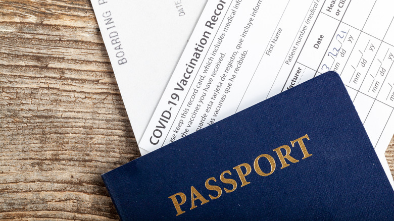 A passport and a vaccination card on a table