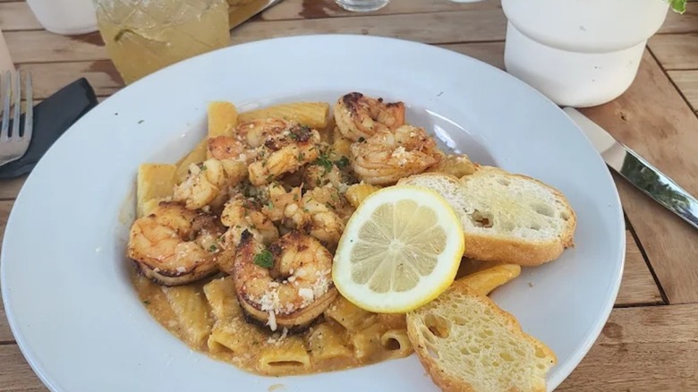 Shrimp and pasta with a cocktail on the patio of Mangos Souther Kitchen and Bar