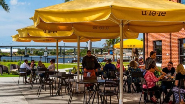 The outdoor patio at Ulele has shaded tables and spacious grounds along the Hillsborough River