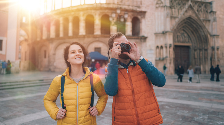 A couple in light winter jackets visiting Valencia