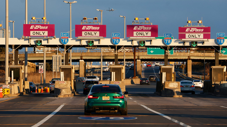 Cars moving through several lanes on a toll road.