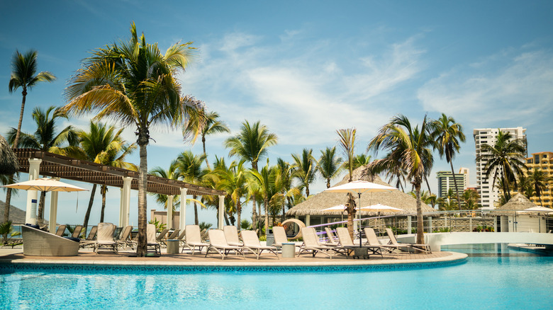 Lounge chairs by the pool at a resort