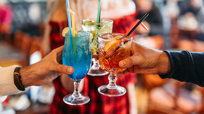 The colorful cocktails in a toast
