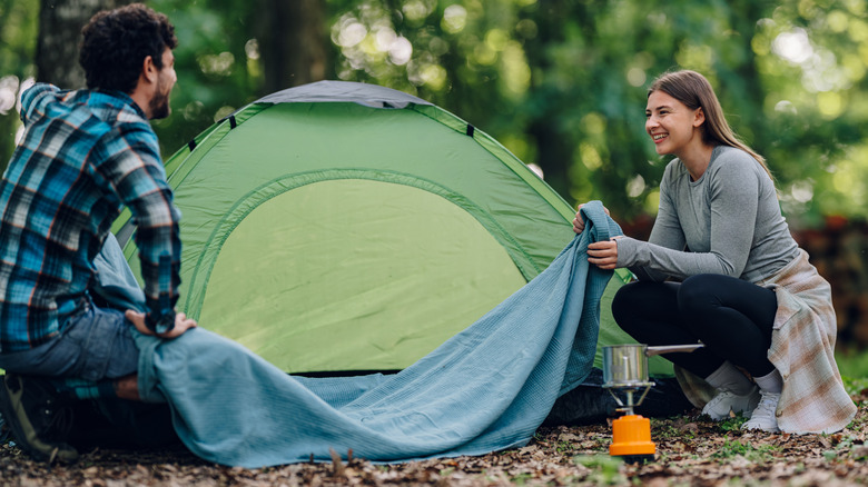 Couple setting up a campsite
