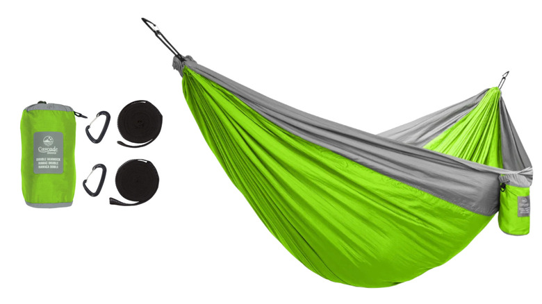 A lime green and grey travel hammock hangs from carabiners.
