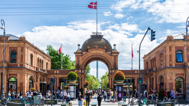 The gate to Tivoli Gardens in Copenhagen, Denmark, with people walking on the street