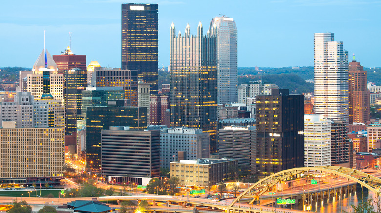 Lights flicker on in the skyscrapers of Downtown Pittsburgh, Pennsylvania
