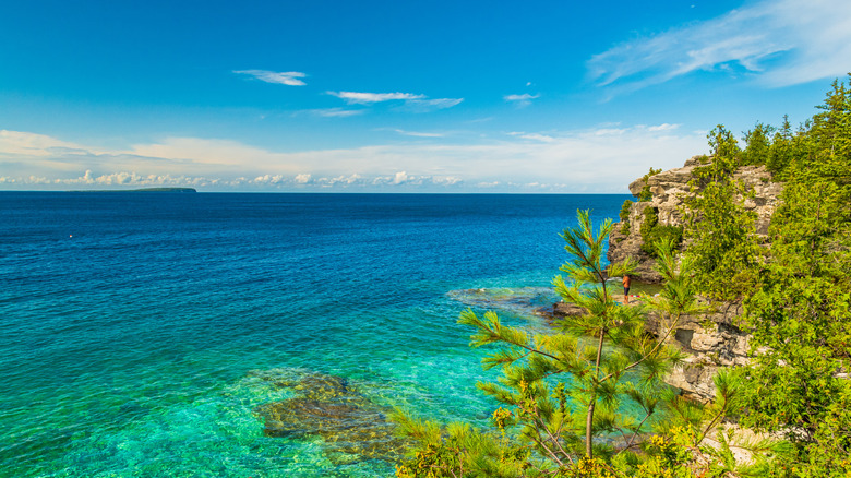 View from the cliffs above Indian Head Cove at the clear multi-hued blue water in Tobermory, Canada