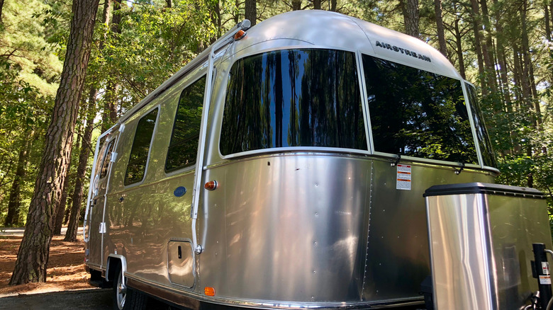 Airstream Bambi parked in the woods