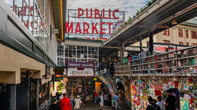 Pike Place Market sign overlooking an alley full of people in Seattle, Washington