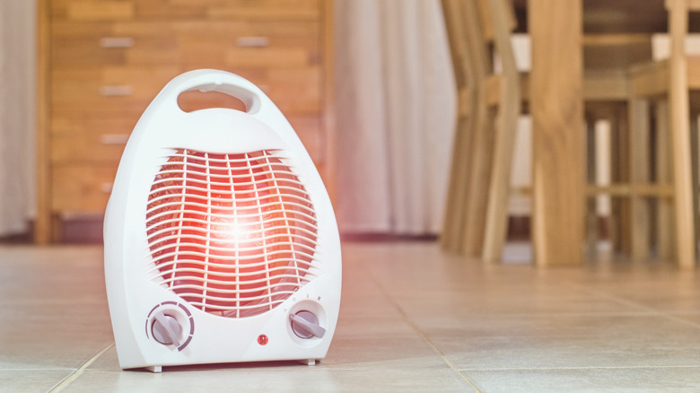 Electric space heater on a tile floor in a home
