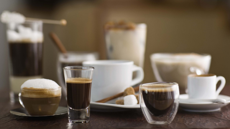 Various cups and glasses filled with different style coffees