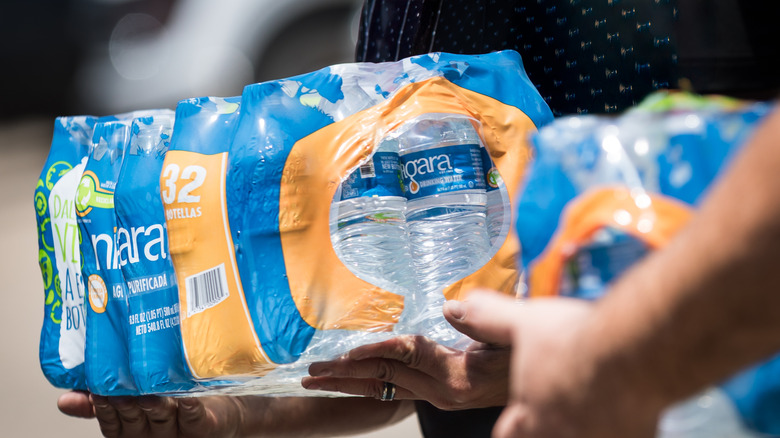 Volunteers holding water to be distributed to disaster victims