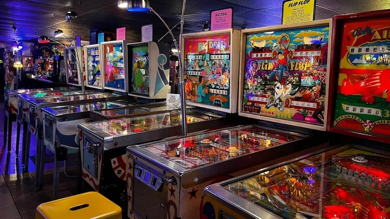 A row of retro pinball machines at the Asheville Pinball Museum.