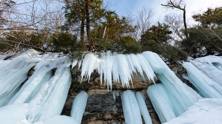 Thick icicles hang off rocks in Munising, Michigan