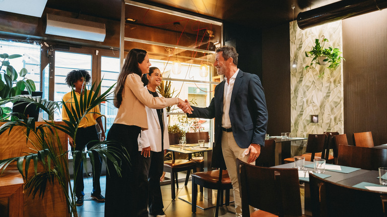 People shaking hands in a restaurant