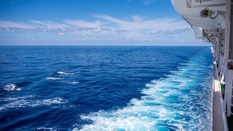 Viewing the open ocean from the side of a cruise ship