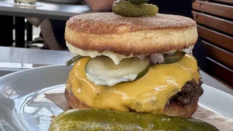 A cheeseburger at Nancy's Hustle with an English muffin bun and pickles
