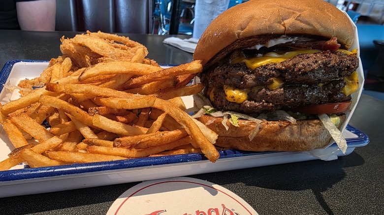 A large double-patty burger and fries at Pappas Burger in Houston