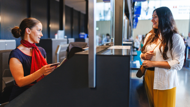 A traveler checking in at airport ticketing counter