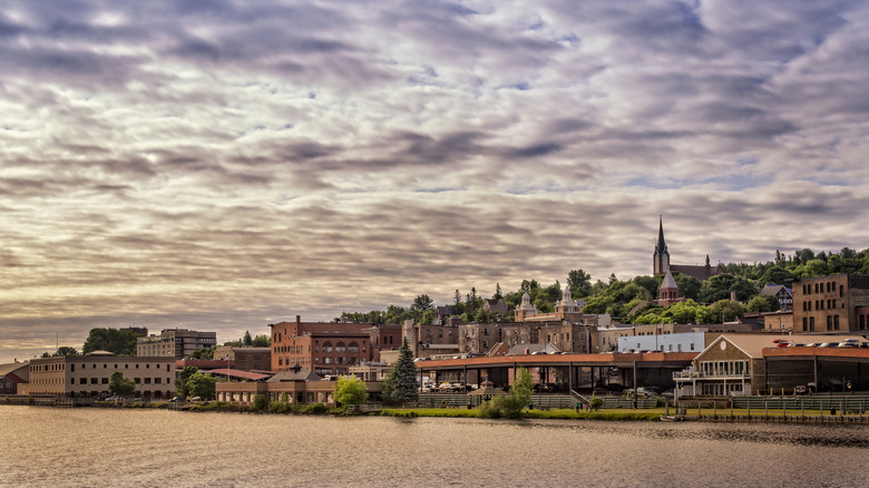 The red brick buildings and church steeple of Houghton from across the Portage Canal